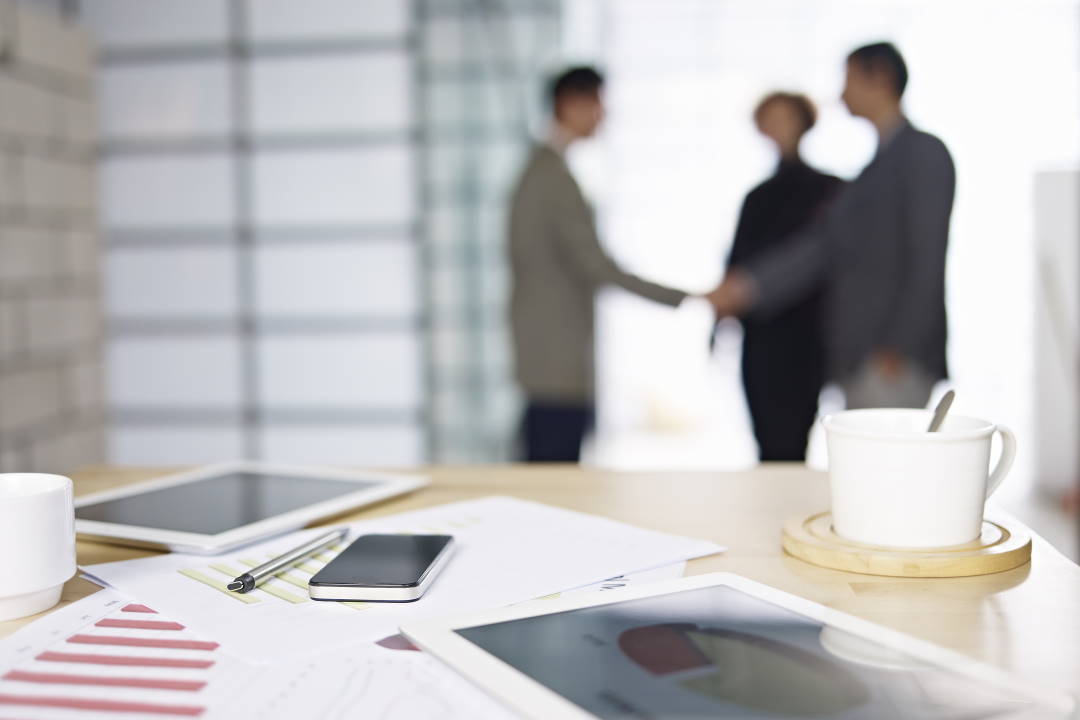 Three people shaking hands after a successful meeting